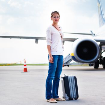 Young woman at an airport having just left the aircraft