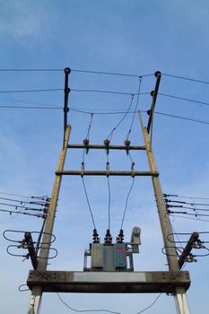 Electricity post with transformer on blue sky background