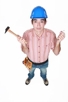Tradesman holding a hammer and a nail