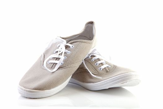 pair of grey sport shoes over white background