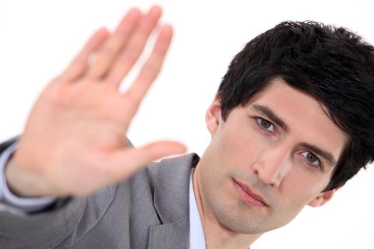 Businessman holding his palm up