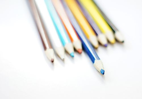 Close up of color pencils with different color over white backgr