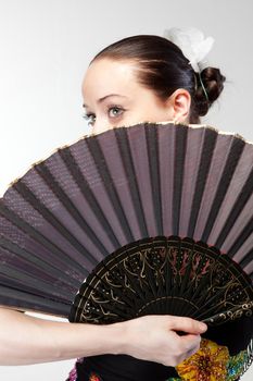 closeup portrait of flamenco dancer with fan 