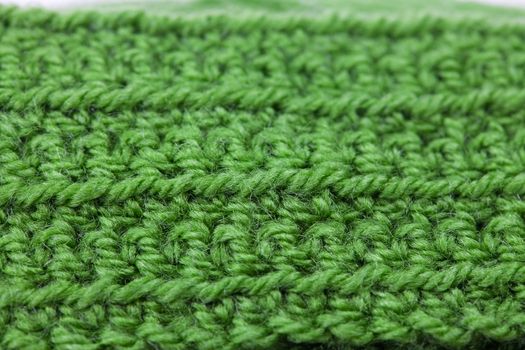 Skein of wool and knitted piece  background