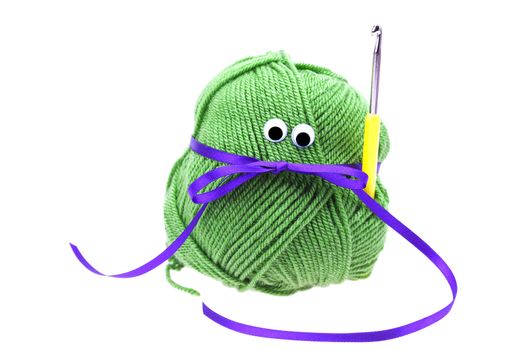 skein of wool  with eyes, ribbon and crochet hooks isolated on w