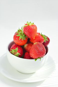 strawberries in a bowl in the daylight