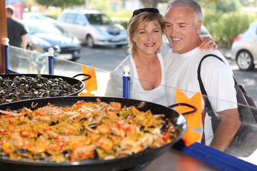 Couple in front of paella