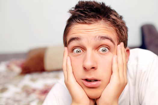 Surprised Teenager lying on the bed in Home interior