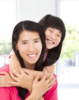 happy asian little girl with her mother