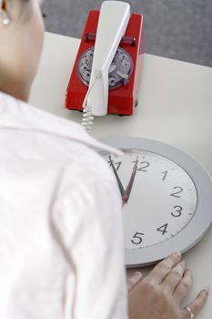 Woman waiting near a clock