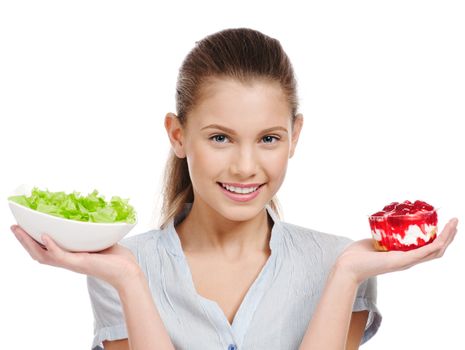 Pretty young woman choice salad or cake. Isolated
