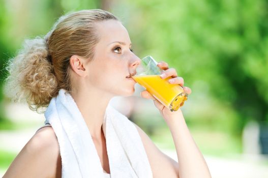Woman drinking juice after exercise