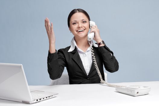 Casual business woman in office talking by phone