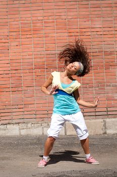 Beautiful teenage girl dancing hip-hop