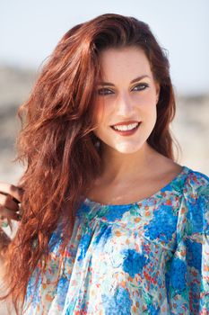 sexy beautiful woman portrait on the beach wearing a blue shirt