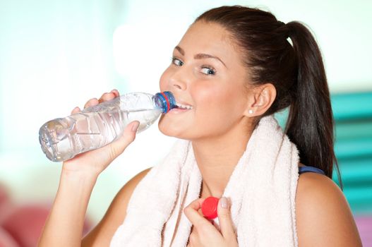Woman drink cold water after sport train.