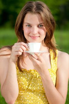 Beautiful young woman drink hot coffee outdoor