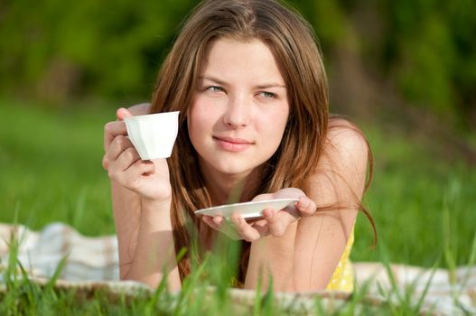 Beautiful young woman drink hot coffee outdoor