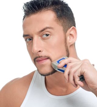 Young handsome man shaving
