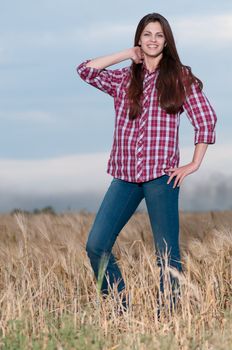 Beautiful cowboy woman posing in field