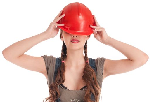 Young playful worker woman in coverall and helmet