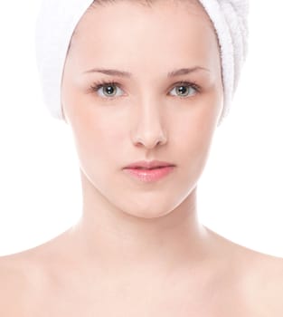 Close-up portrait of young woman with perfect health skin of face and bath towel on head. Isolated on white