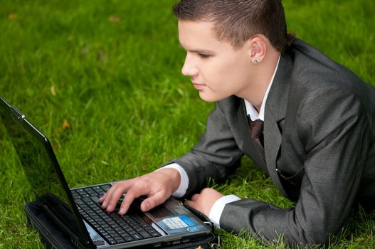 business man work on notebook at park. Student