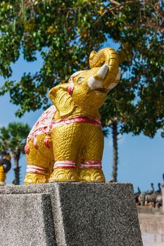 Thai stone elephant on a pedestal on a sunny day