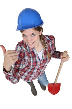 young female bricklayer holding shovel