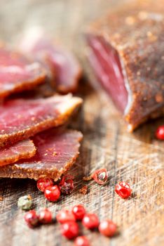 Slices of cured meet and pepper on table