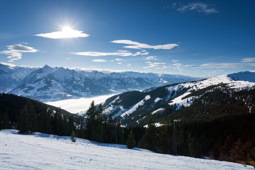 winter with ski slopes of kaprun resort next to kitzsteinhorn peak in austrian alps