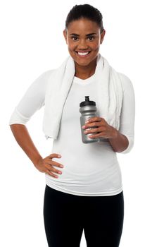 Fitness freak holding sipper, towel around her neck