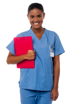 Active female nurse holding clipboard, at duty