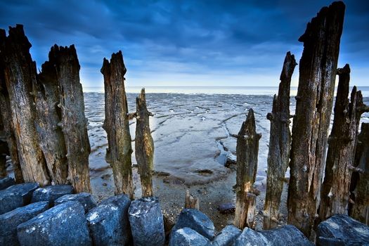 wooden dike and mud at low tide