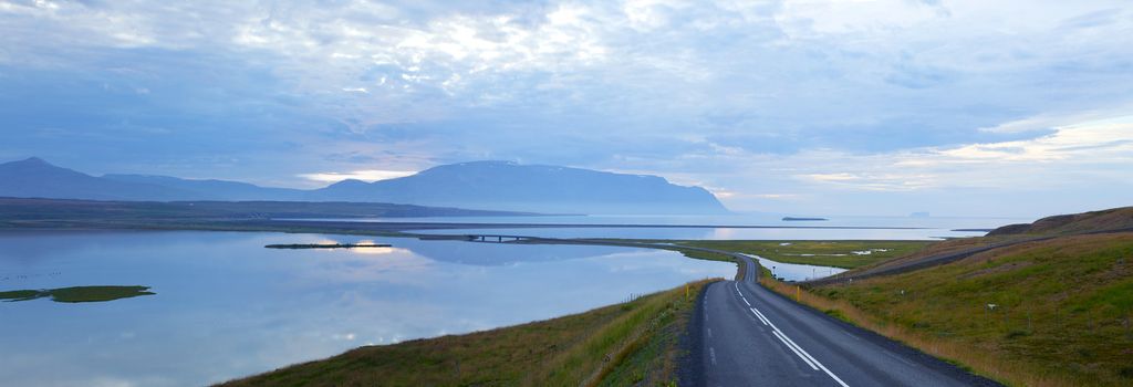 Highway through Iceland landscape at foggy day. Panorama