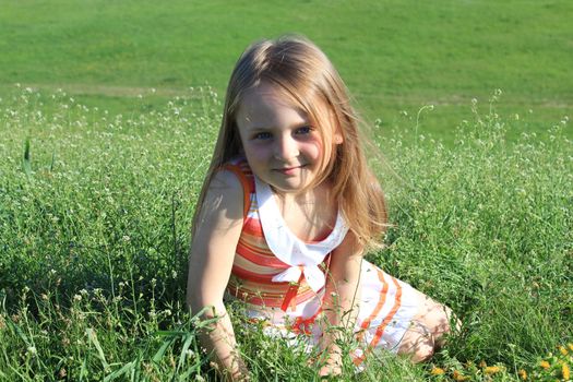 portrait of little fashionable girl on the nature
