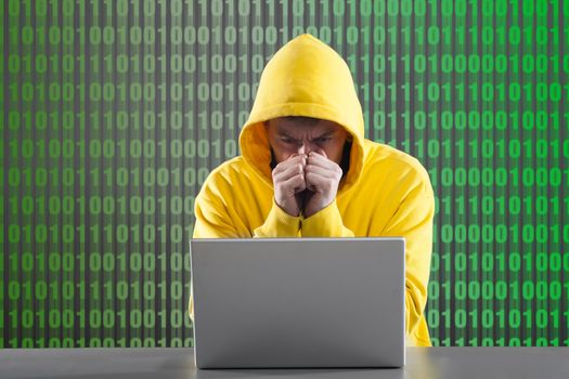 man in a yellow jacket working on the Internet