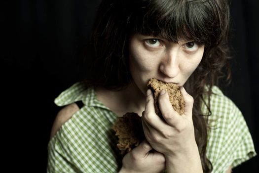 beggar woman eating bread 