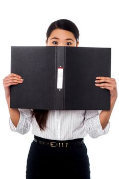 Woman hiding her face with a business file