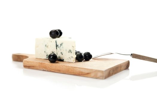 blue cheese and black olives on cheeseboard