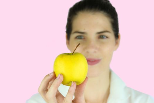 Girl holding a yellow apple