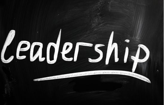 The word "Leadership" handwritten with white chalk on a blackboa