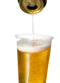 Golden lager or beer in disposable plastic cup