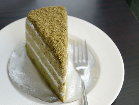 Matcha green tea cake in white dish