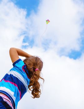 Little girl with windy kite