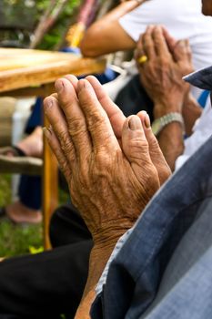 Grandpa hands in Buddhist ritual