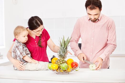 Father is preparing fruit for child 