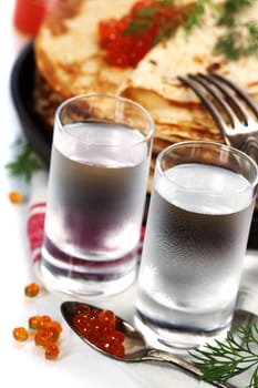 Russian vodka with pancakes and red caviar