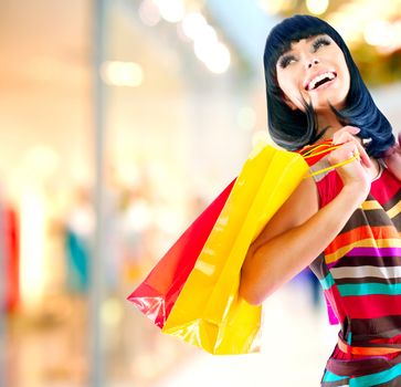 Beauty Woman with Shopping Bags in Shopping Mall 