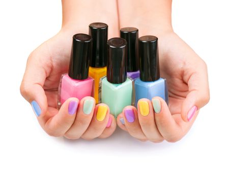 Nail Polish. Manicure. Colored Nail Polish Bottles in the hands 